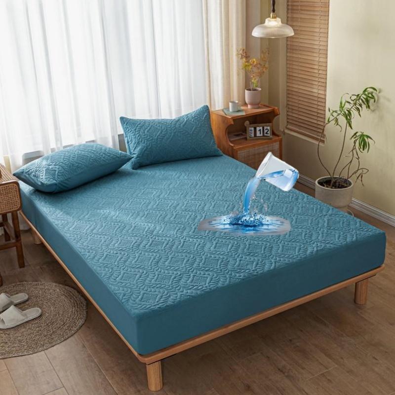 Blue mattress cover on a bed in a bedroom with water droplet effect